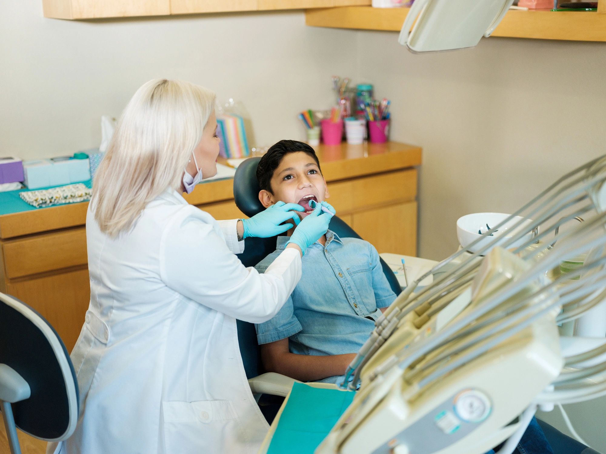 Dentist performing careful dental treatment on a patient