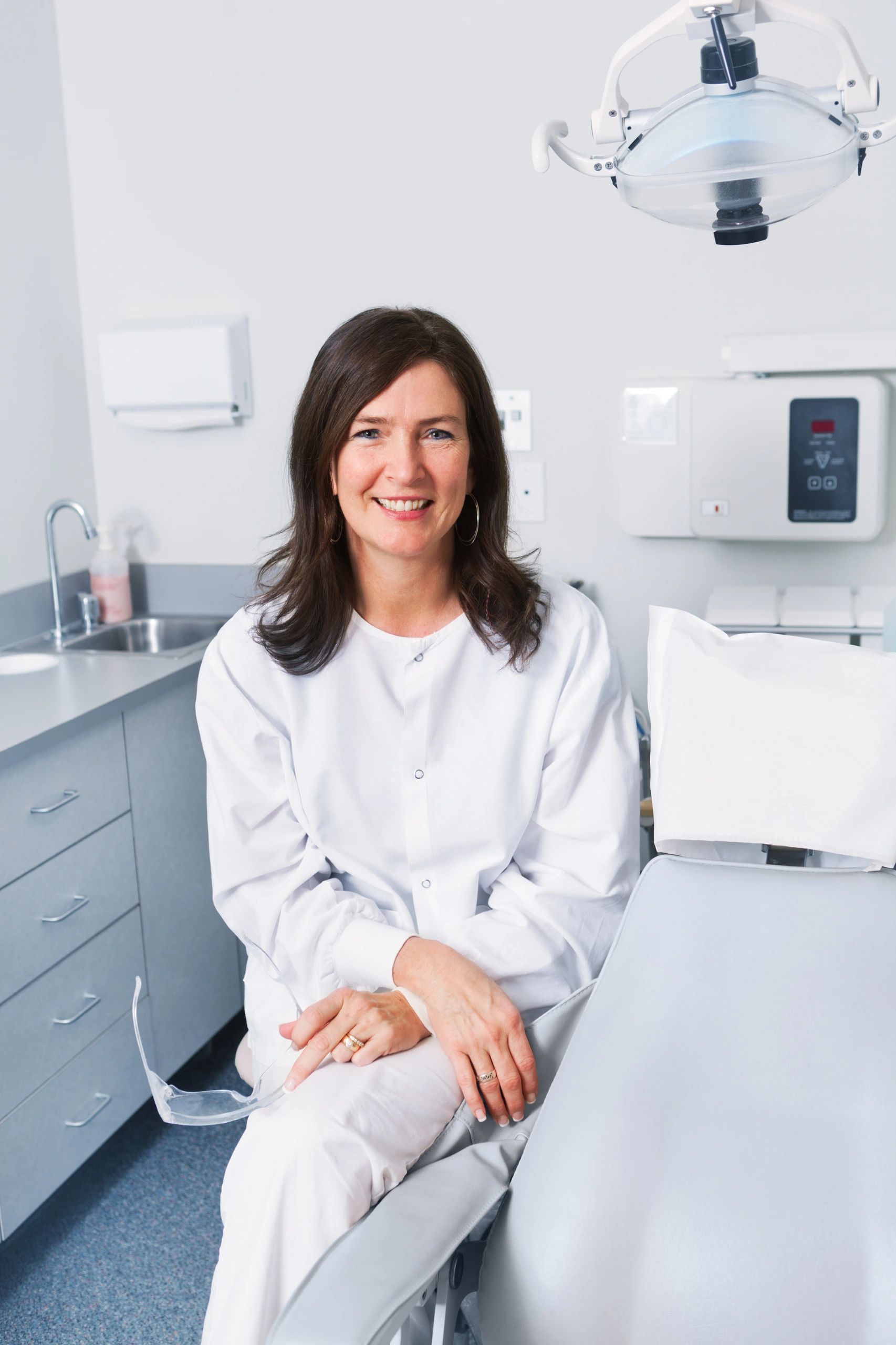 Dental professional standing in a modern clinic