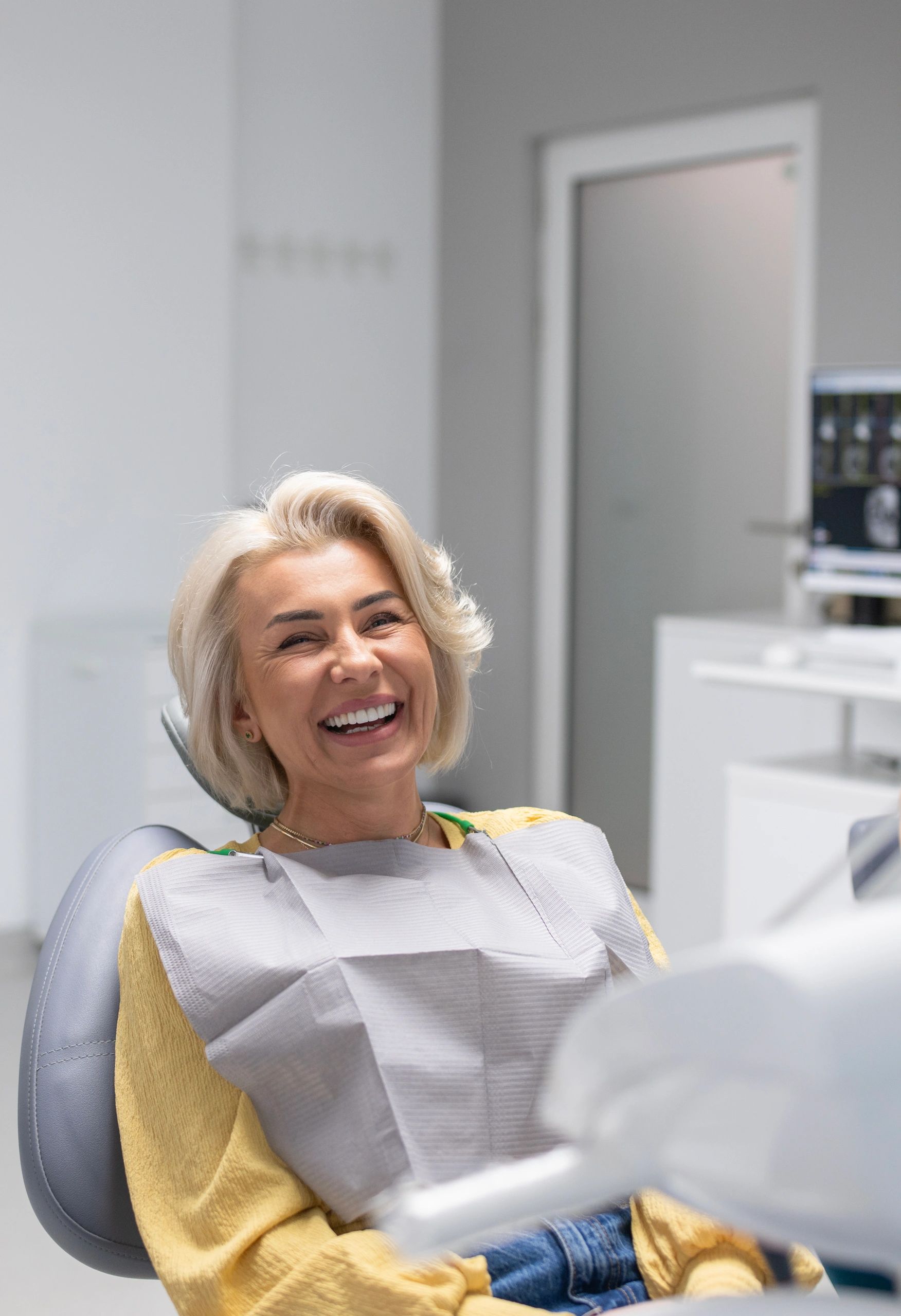 Emergency Dentistry Smiling dental patient in a comfortable dental office