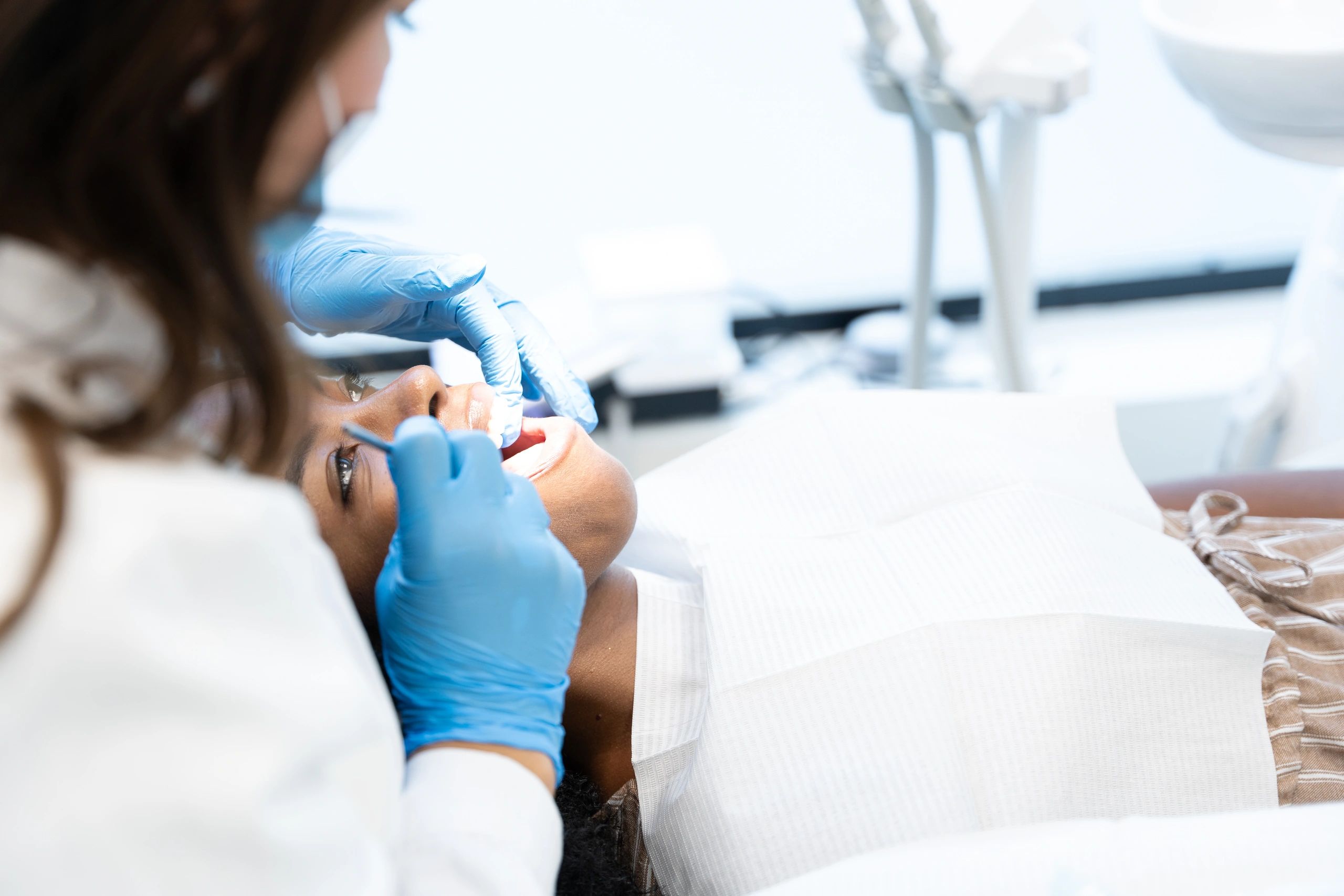 Dentist examining a patient during an urgent dental visit